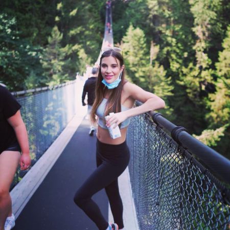 Rachel Sheen is posing by resting her hand on the bridge.